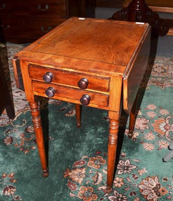 Lot 652 - A small work table with two end drawers and turned legs