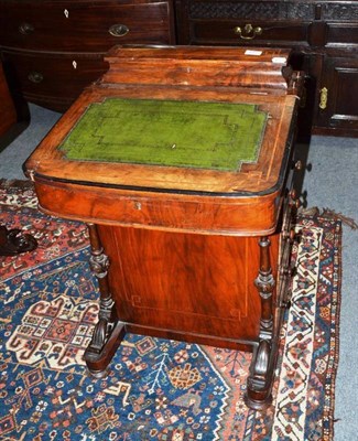 Lot 655 - A Victorian walnut Davenport with leather inset top