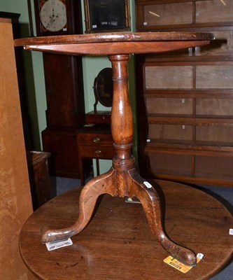 Lot 677 - An oak tripod table on turned column