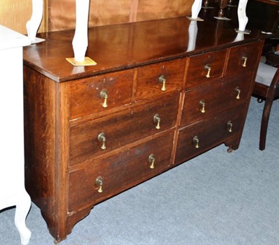 Lot 682 - An early 20th century oak sideboard with an arrangement of eight drawers