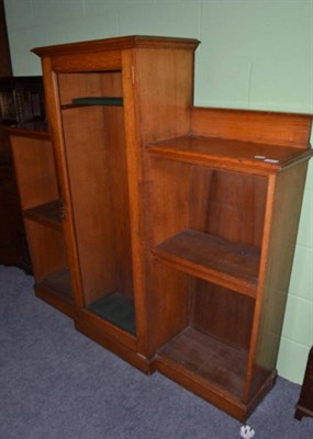 Lot 691 - A glazed oak gun cabinet with fitted shelves