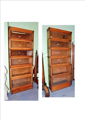 Lot 696 - A pair of Globe Wernicke oak eight section bookcases