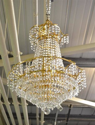 Lot 719 - A gilt metal chandelier with cut glass drops