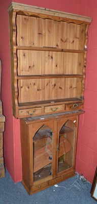 Lot 748 - A pine dresser rack and a glazed cabinet