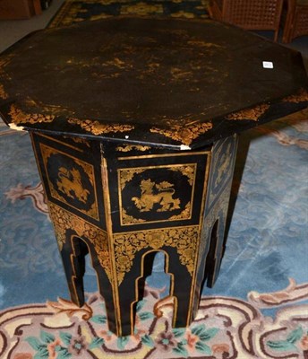 Lot 795 - A black and gilt Japanned octagonal folding table, the lower section decorated with Chinese dragons