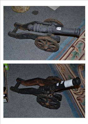 Lot 857 - A pair of black painted cast iron model cannons, each with 45cm ringed barrel cast with a...