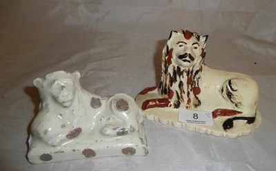 Lot 8 - An English Creamware pottery recumbent lion circa 1800 and a white glazed porcelain recumbent...