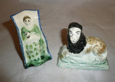 Lot 9 - A Prattware pottery recumbent lion circa 1790 and another as a woman with cat in rocking chair (2)