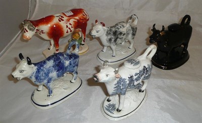 Lot 22 - Five pottery cow creamers