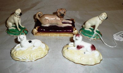 Lot 25 - A group of five assorted porcelain and pottery models of dogs including two Derby (type) Pugs,...