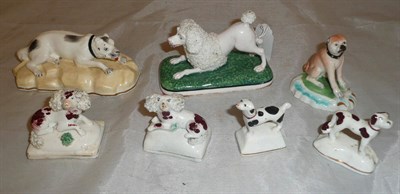 Lot 26 - A group of seven assorted porcelain and pottery models of dogs including a Derby Pug and a...