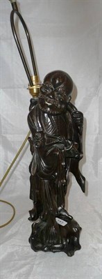 Lot 143 - An Eastern carved hardwood lamp base modelled as a scholar