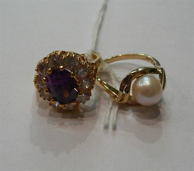 Lot 209 - A 9ct gold and pearl ring and an amethyst and cubic zirconia cluster ring stamped '14K'