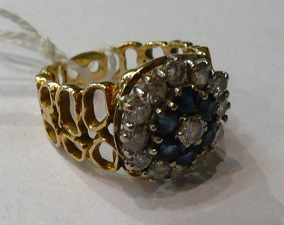 Lot 216 - A diamond and sapphire ring on yellow metal band