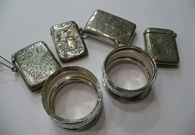 Lot 220 - A silver vesta case, three white metal vesta cases and two silver napkin rings