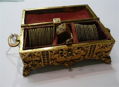 Lot 222 - A gilt metal casket containing approximately thirty gaming tokens as spade guineas and dice