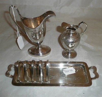 Lot 243 - White metal toast rack, Georgian style cream jug and a Victorian cream jug