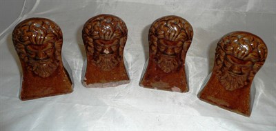 Lot 389 - A set of four treacle glaze window rests