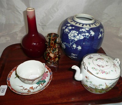 Lot 399 - A Chinese sang de boeuf bottle vase, a blue and white ginger jar, a tea kettle, a cup and...