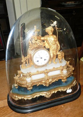 Lot 515 - A gilt metal and onyx striking mantel clock beneath glass dome