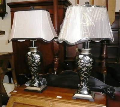 Lot 595 - Pair of modern black and silver table lamps and shades