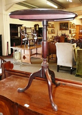 Lot 620 - An oak tripod table with tilt top