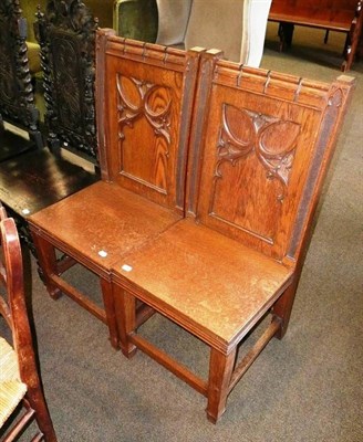 Lot 641 - A pair of carved oak ecclesiastical style chairs