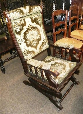 Lot 643 - An American rocker with upholstered seat and back