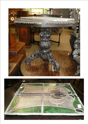 Lot 670 - An Anglo-Indian type carved centre table and two Art Nouveau stained glass panels