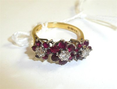 Lot 44 - An 18ct gold ruby and diamond triple cluster ring