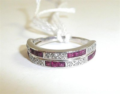 Lot 46 - A diamond and ruby set half eternity ring