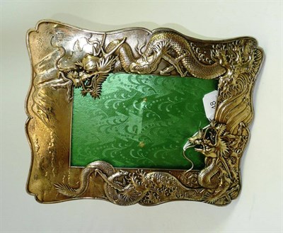 Lot 48 - An early 20th century Chinese gilt metal photograph frame, decorated with two fire dragons, signed