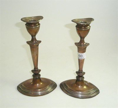 Lot 60 - A pair of hallmarked silver elliptical candlesticks