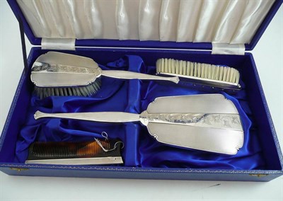 Lot 104 - A cased hallmarked silver brush and mirror set