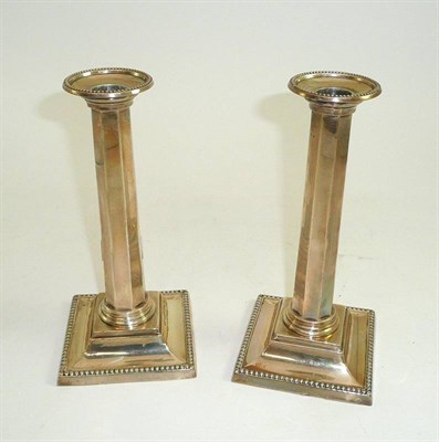 Lot 110 - A pair of silver column candlesticks