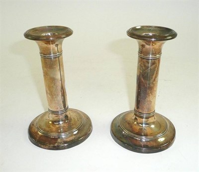 Lot 111 - A pair of silver candlesticks