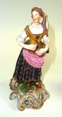 Lot 122 - A Bloor Derby figure of a woman picked out in bright enamels, on scroll moulded base, 20cm