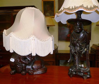 Lot 134 - A carved hardwood figural lamp base and another