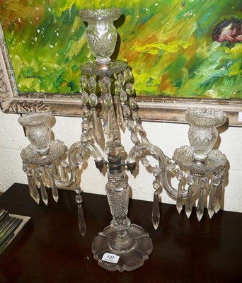 Lot 137 - A cut glass three branch candelabra, hung with drops on a cut glass base, 53cm