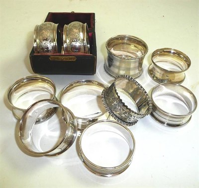 Lot 163 - A cased pair of silver napkin rings and eight other silver napkin rings