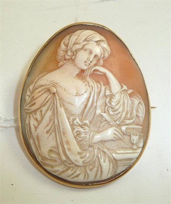 Lot 167 - A carved shell cameo brooch in rubber-over frame