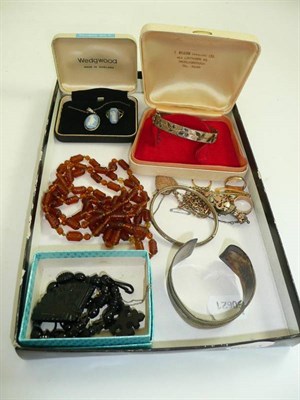 Lot 180 - A silver bangle, a jet watch chain, four 9ct gold rings, a locket and chain etc