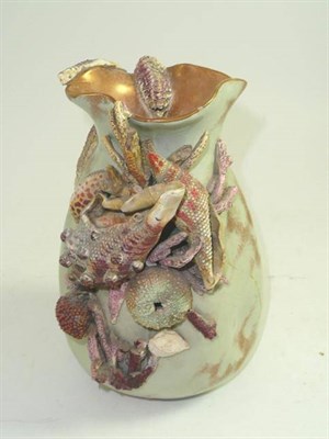 Lot 212 - An English earthenware vase encrusted with shells and star fish, lozenge mark, 20cm