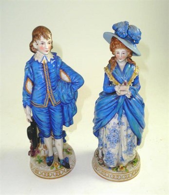 Lot 213 - A pair of late 19th century French blue decorated figures of a boy and a girl, 25cm