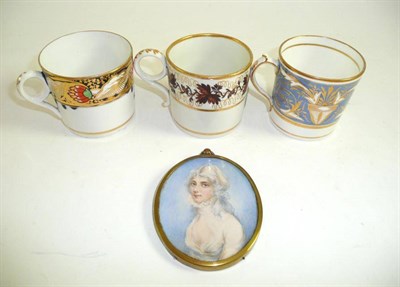 Lot 254 - Three early 19th century porcelain coffee cans and an oval portrait of a young lady