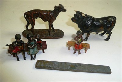 Lot 295 - A small bronze figure of a bull, a bronze whippet, two small cold painted bronze figures of a black