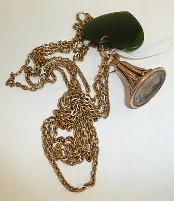 Lot 298 - A long length chain hung with a crested rock crystal intaglio seal fob and a jade heart pendant