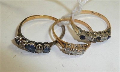 Lot 330 - A diamond three stone ring, a sapphire and diamond five stone ring and another (one stone missing)