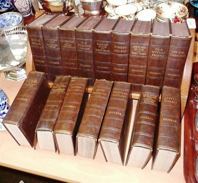 Lot 345 - A Thompson of Kilburn oak book trough and a set of Dickens works