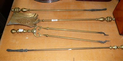 Lot 440 - A set of brass fire irons